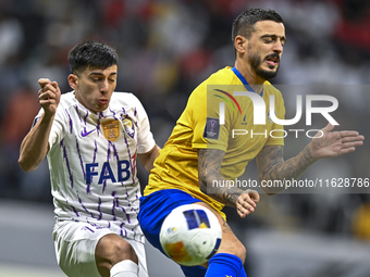 Jose Luis Mato of Al Gharafa SC battles for the ball with Mateo Sanabria of Al Ain FC during the AFC Champions League elite west football ma...