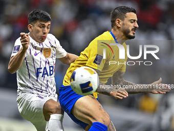 Jose Luis Mato of Al Gharafa SC battles for the ball with Mateo Sanabria of Al Ain FC during the AFC Champions League elite west football ma...