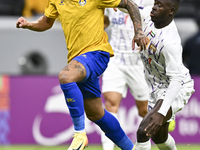 Florinel Teodor Coman (L) of Al Gharafa SC and Mateo Sanabria of Abdoul Karim Traore are in action during the AFC Champions League elite wes...