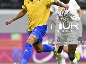 Florinel Teodor Coman (L) of Al Gharafa SC and Mateo Sanabria of Abdoul Karim Traore are in action during the AFC Champions League elite wes...