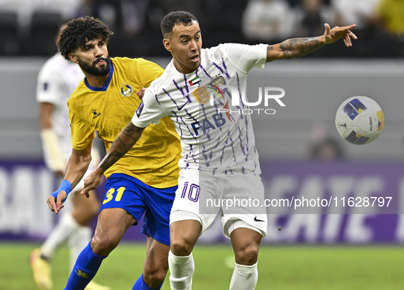 Ferjani Sassi (L) of Al Gharafa SC battles for the ball with Kaku of Al Ain FC during the AFC Champions League elite west football match bet...