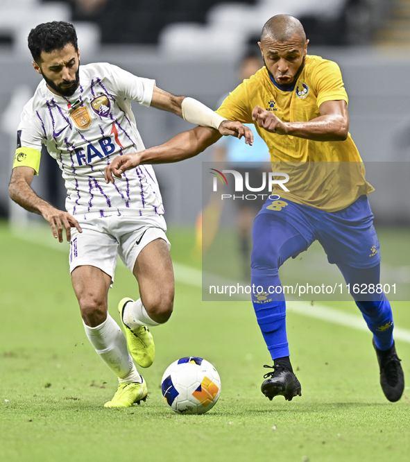 Yacine Brahimi (R) of Al Gharafa SC and Bandar Al Ahbabi of Al Ain FC are in action during the AFC Champions League elite west football matc...