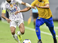 Yacine Brahimi (R) of Al Gharafa SC and Bandar Al Ahbabi of Al Ain FC are in action during the AFC Champions League elite west football matc...