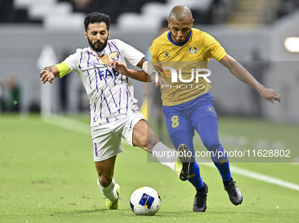 Yacine Brahimi (R) of Al Gharafa SC and Bandar Al Ahbabi of Al Ain FC are in action during the AFC Champions League elite west football matc...