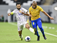 Yacine Brahimi (R) of Al Gharafa SC and Bandar Al Ahbabi of Al Ain FC are in action during the AFC Champions League elite west football matc...