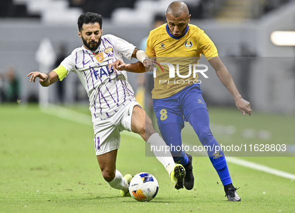 Yacine Brahimi (R) of Al Gharafa SC and Bandar Al Ahbabi of Al Ain FC are in action during the AFC Champions League elite west football matc...