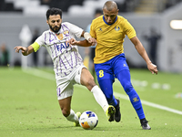 Yacine Brahimi (R) of Al Gharafa SC and Bandar Al Ahbabi of Al Ain FC are in action during the AFC Champions League elite west football matc...