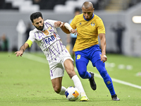 Yacine Brahimi (R) of Al Gharafa SC and Bandar Al Ahbabi of Al Ain FC are in action during the AFC Champions League elite west football matc...