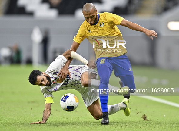 Yacine Brahimi (R) of Al Gharafa SC and Bandar Al Ahbabi of Al Ain FC are in action during the AFC Champions League elite west football matc...