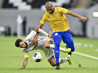 Yacine Brahimi (R) of Al Gharafa SC and Bandar Al Ahbabi of Al Ain FC are in action during the AFC Champions League elite west football matc...