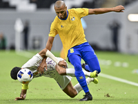 Yacine Brahimi (R) of Al Gharafa SC and Bandar Al Ahbabi of Al Ain FC are in action during the AFC Champions League elite west football matc...