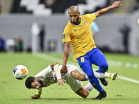 Yacine Brahimi (R) of Al Gharafa SC and Bandar Al Ahbabi of Al Ain FC are in action during the AFC Champions League elite west football matc...