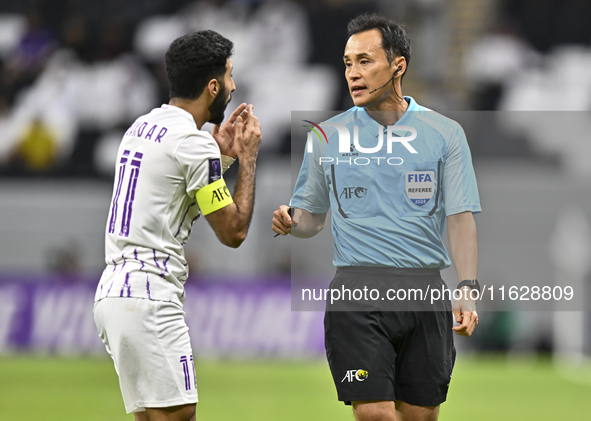 Japanese referee Hiroyuki Kimura gestures during the AFC Champions League elite west football match between Qatar's Al Gharafa SC and United...