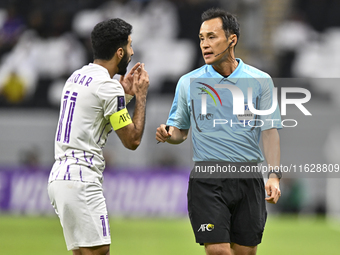 Japanese referee Hiroyuki Kimura gestures during the AFC Champions League elite west football match between Qatar's Al Gharafa SC and United...