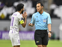 Japanese referee Hiroyuki Kimura gestures during the AFC Champions League elite west football match between Qatar's Al Gharafa SC and United...