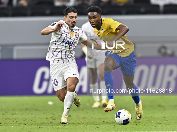 Saifeldeen Hassan Fadlalla (R) of Al Gharafa SC battles for the ball with Kaku of Al Ain FC during the AFC Champions League elite west footb...