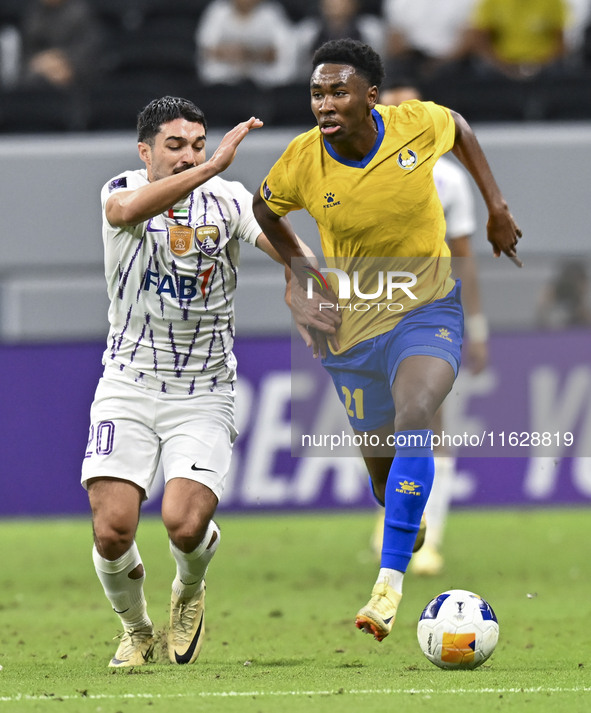 Saifeldeen Hassan Fadlalla (R) of Al Gharafa SC battles for the ball with Kaku of Al Ain FC during the AFC Champions League elite west footb...