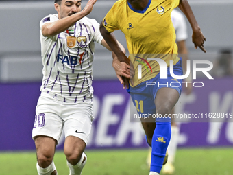 Saifeldeen Hassan Fadlalla (R) of Al Gharafa SC battles for the ball with Kaku of Al Ain FC during the AFC Champions League elite west footb...