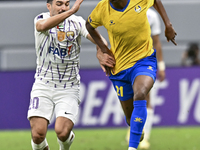 Saifeldeen Hassan Fadlalla (R) of Al Gharafa SC battles for the ball with Kaku of Al Ain FC during the AFC Champions League elite west footb...