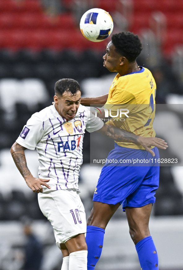 Saifeldeen Hassan Fadlalla (R) of Al Gharafa SC battles for the ball with Kaku of Al Ain FC during the AFC Champions League elite west footb...