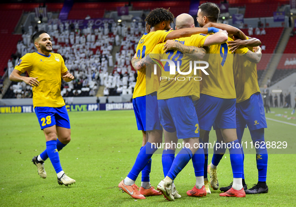 Players of Al Gharafa SC celebrate after scoring a goal during the AFC Champions League elite west football match between Qatar's Al Gharafa...