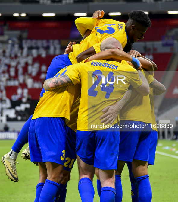 Players of Al Gharafa SC celebrate after scoring a goal during the AFC Champions League elite west football match between Qatar's Al Gharafa...