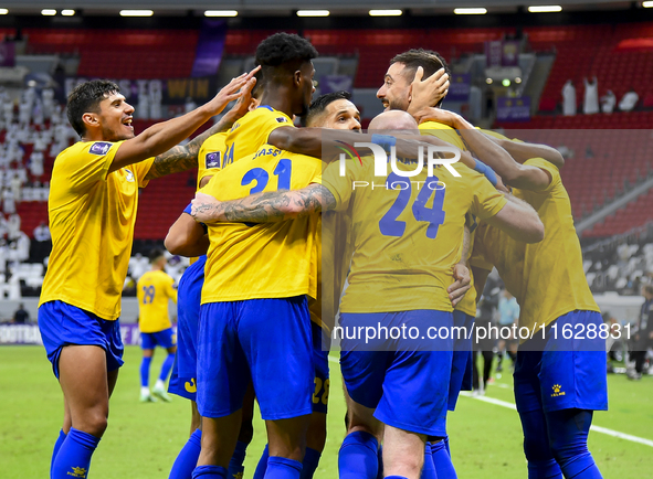 Players of Al Gharafa SC celebrate after scoring a goal during the AFC Champions League elite west football match between Qatar's Al Gharafa...