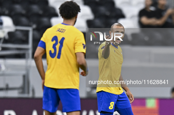 Yacine Brahimi (R) of Al Gharafa SC celebrates after scoring a goal during the AFC Champions League elite west football match between Qatar'...