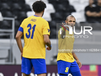 Yacine Brahimi (R) of Al Gharafa SC celebrates after scoring a goal during the AFC Champions League elite west football match between Qatar'...