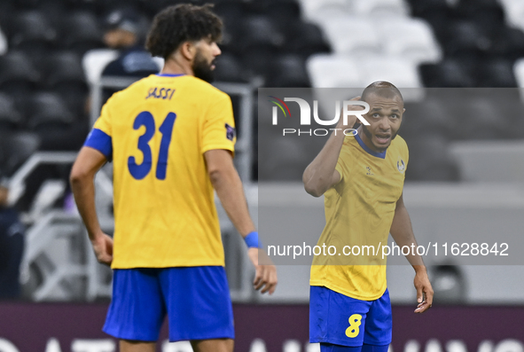 Yacine Brahimi (R) of Al Gharafa SC celebrates after scoring a goal during the AFC Champions League elite west football match between Qatar'...