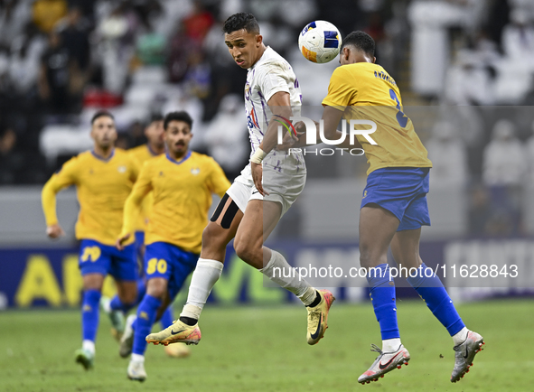 Abdallah Sirelkhatim (R) of Al Gharafa SC battles for the ball with Soufiane Rahimi of Al Ain FC during the AFC Champions League elite west...