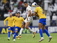 Abdallah Sirelkhatim (R) of Al Gharafa SC battles for the ball with Soufiane Rahimi of Al Ain FC during the AFC Champions League elite west...