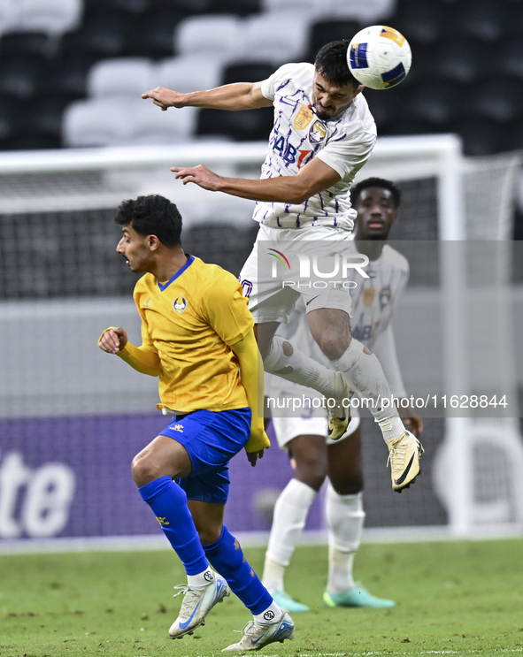 Ahmed Alganehi of Al Gharafa SC battles for the ball with Matias Palacios of Al Ain FC during the AFC Champions League elite west football m...