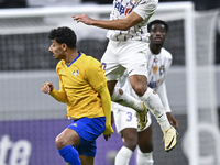 Ahmed Alganehi of Al Gharafa SC battles for the ball with Matias Palacios of Al Ain FC during the AFC Champions League elite west football m...