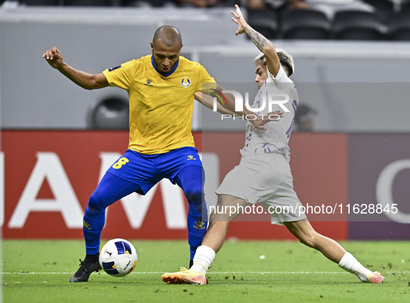 Yacine Brahimi (L) of Al Gharafa SC and Matias Segovia of Al Ain FC in action during the AFC Champions League elite west football match betw...