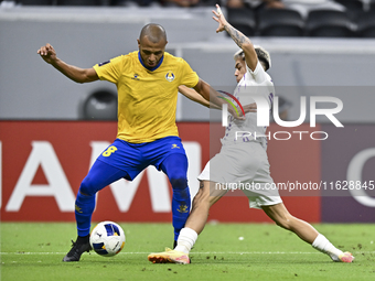 Yacine Brahimi (L) of Al Gharafa SC and Matias Segovia of Al Ain FC in action during the AFC Champions League elite west football match betw...