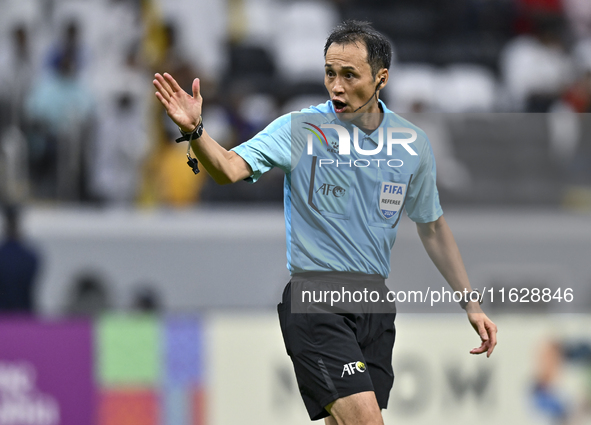 Japanese referee Hiroyuki Kimura gestures during the AFC Champions League elite west football match between Qatar's Al Gharafa SC and United...