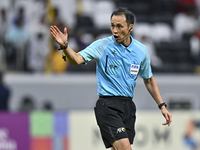 Japanese referee Hiroyuki Kimura gestures during the AFC Champions League elite west football match between Qatar's Al Gharafa SC and United...