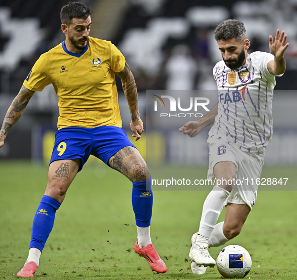 Jose Luis Mato of Al Gharafa SC battles for the ball with Yahia Nader of Al Ain FC during the AFC Champions League elite west football match...