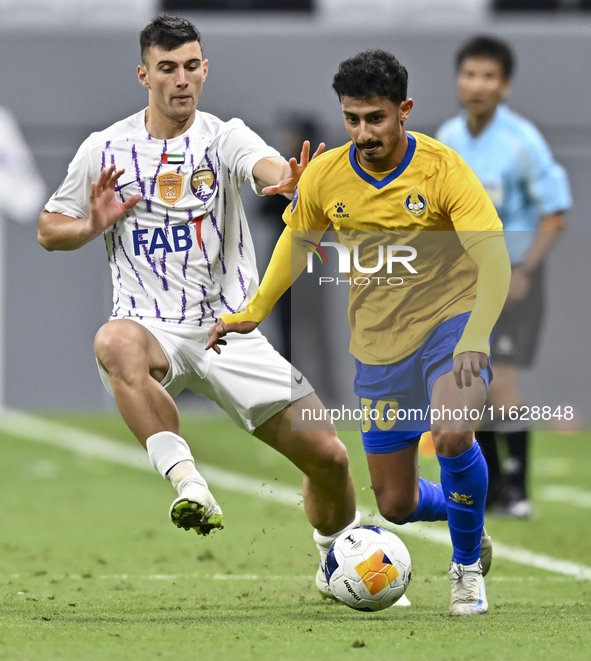 Ahmed Alganehi of Al Gharafa SC battles for the ball with Felipe Salomoni of Al Ain FC during the AFC Champions League elite west football m...