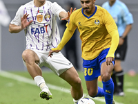 Ahmed Alganehi of Al Gharafa SC battles for the ball with Felipe Salomoni of Al Ain FC during the AFC Champions League elite west football m...