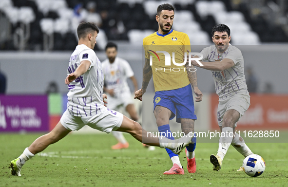 Jose Luis Mato of Al Gharafa SC and Matias Palacios of Al Ain FC are in action during the AFC Champions League elite west football match bet...