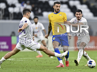 Jose Luis Mato of Al Gharafa SC and Matias Palacios of Al Ain FC are in action during the AFC Champions League elite west football match bet...