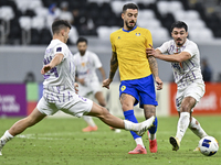 Jose Luis Mato of Al Gharafa SC and Matias Palacios of Al Ain FC are in action during the AFC Champions League elite west football match bet...