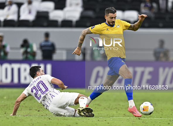 Jose Luis Mato of Al Gharafa SC battles for the ball with Matias Palacios of Al Ain FC during the AFC Champions League elite west football m...