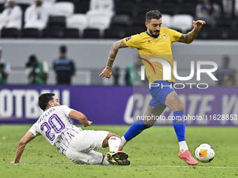 Jose Luis Mato of Al Gharafa SC battles for the ball with Matias Palacios of Al Ain FC during the AFC Champions League elite west football m...