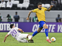 Jose Luis Mato of Al Gharafa SC battles for the ball with Matias Palacios of Al Ain FC during the AFC Champions League elite west football m...