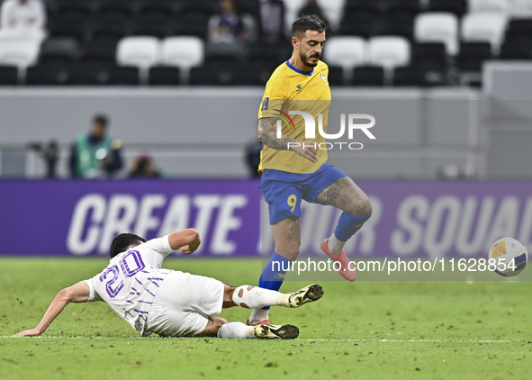 Jose Luis Mato of Al Gharafa SC battles for the ball with Matias Palacios of Al Ain FC during the AFC Champions League elite west football m...