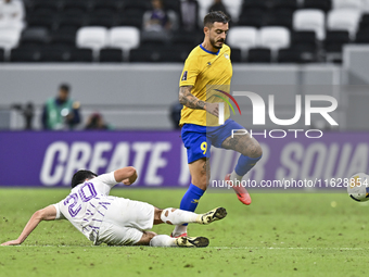 Jose Luis Mato of Al Gharafa SC battles for the ball with Matias Palacios of Al Ain FC during the AFC Champions League elite west football m...