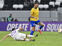 Jose Luis Mato of Al Gharafa SC battles for the ball with Matias Palacios of Al Ain FC during the AFC Champions League elite west football m...